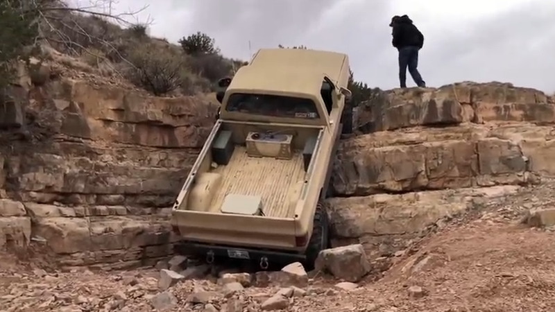 改造トラックのCUCVが崖を昇る。